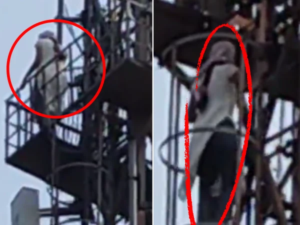Young girl climbs mobile tower