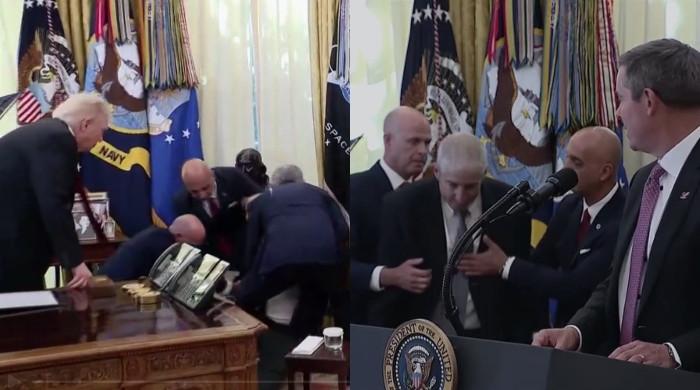 A man standing in front of Trump suddenly fainted