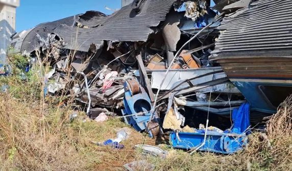 Passenger train hits fallen crane on track