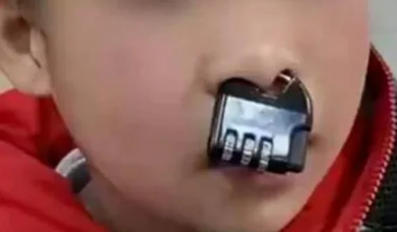Naughty child puts a lock in his nose