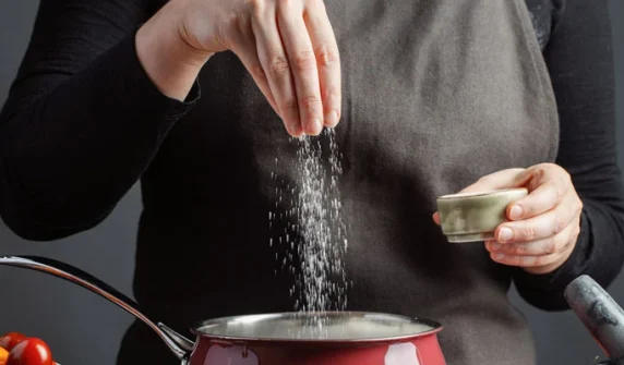 What dangerous problem is associated with adding extra salt to food?