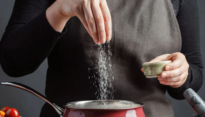 What dangerous problem is associated with adding extra salt to food?
