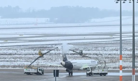 Rain and snow cause water to freeze on the runway