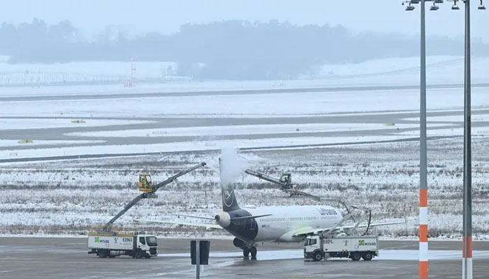 Rain and snow cause water to freeze on the runway