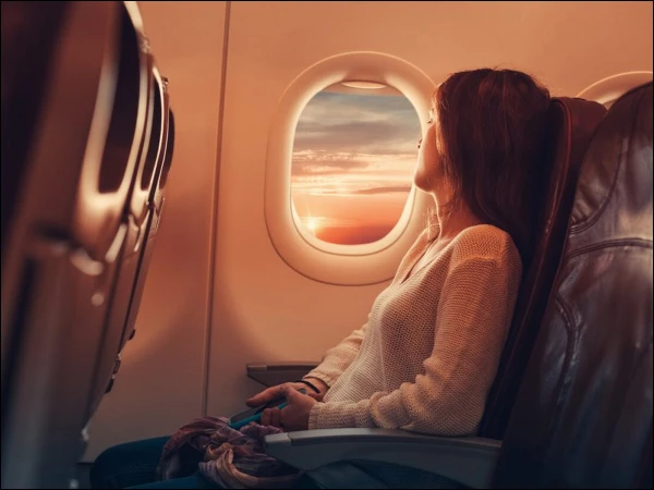 Why are window curtains removed before a plane lands?