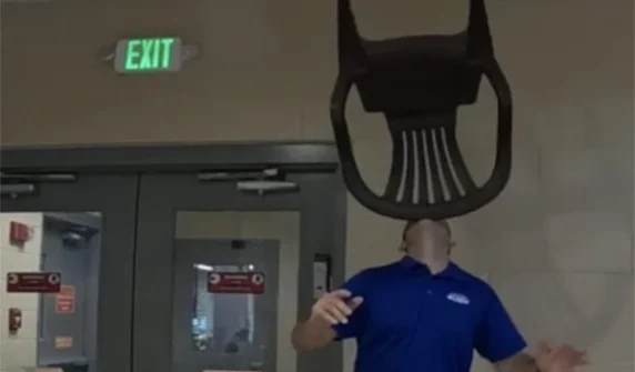Unique feat of balancing a chair on the chin