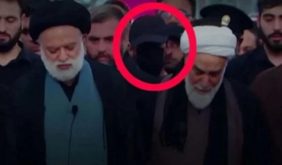 Who was the mysterious masked figure at Ali Khamenei's funeral?