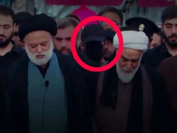 Who was the mysterious masked figure at Ali Khamenei's funeral?