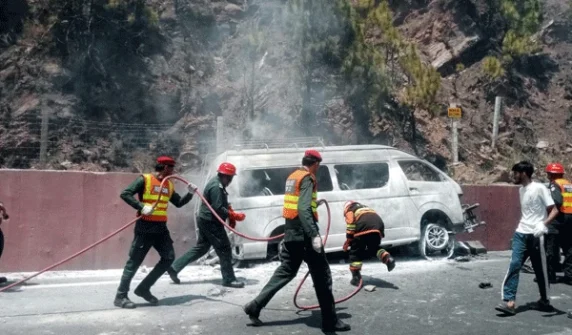 A school van that fell off the road caught fire