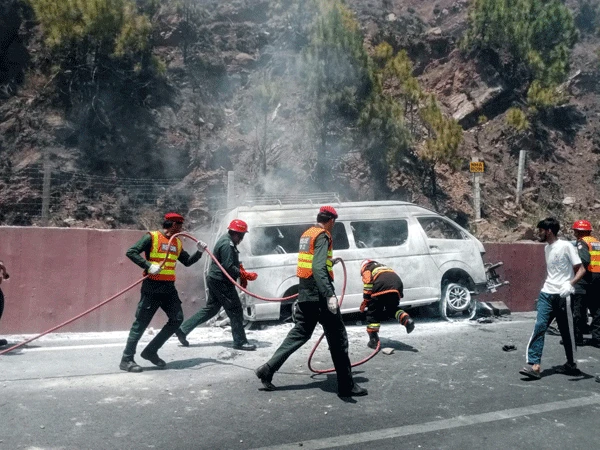 A school van that fell off the road caught fire
