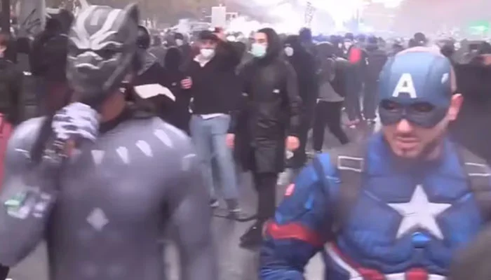 People participate in anti-government protests wearing superhero costumes